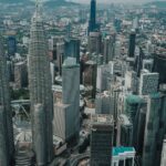 Aerial view Kuala Lumpur city with famous Petronas Twin Towers surrounded with glass skyscrapers and urban architecture