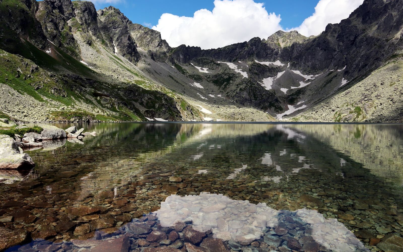 Průzračné horské pleso pod skalními štíty Vysokých Tater